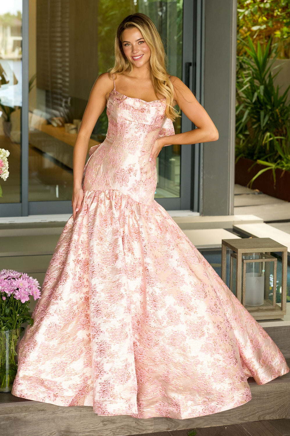 Ava Presley 26419 Blush mermaid prom dress with ruffled neckline and elegant floral detailing.