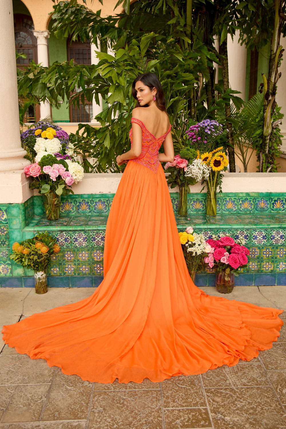 Ava Presley 47254 Orange prom dress with a flowing skirt and intricate beading, back view.