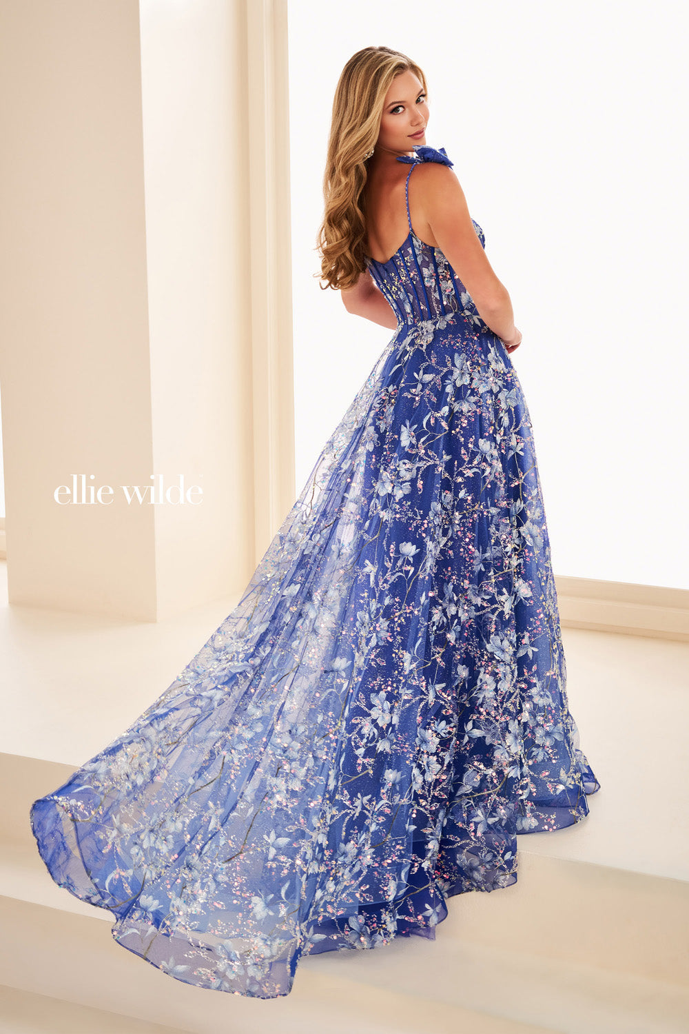 Ellie Wilde EW37020 blue floral gown with flowing, layered skirt prom dress images.