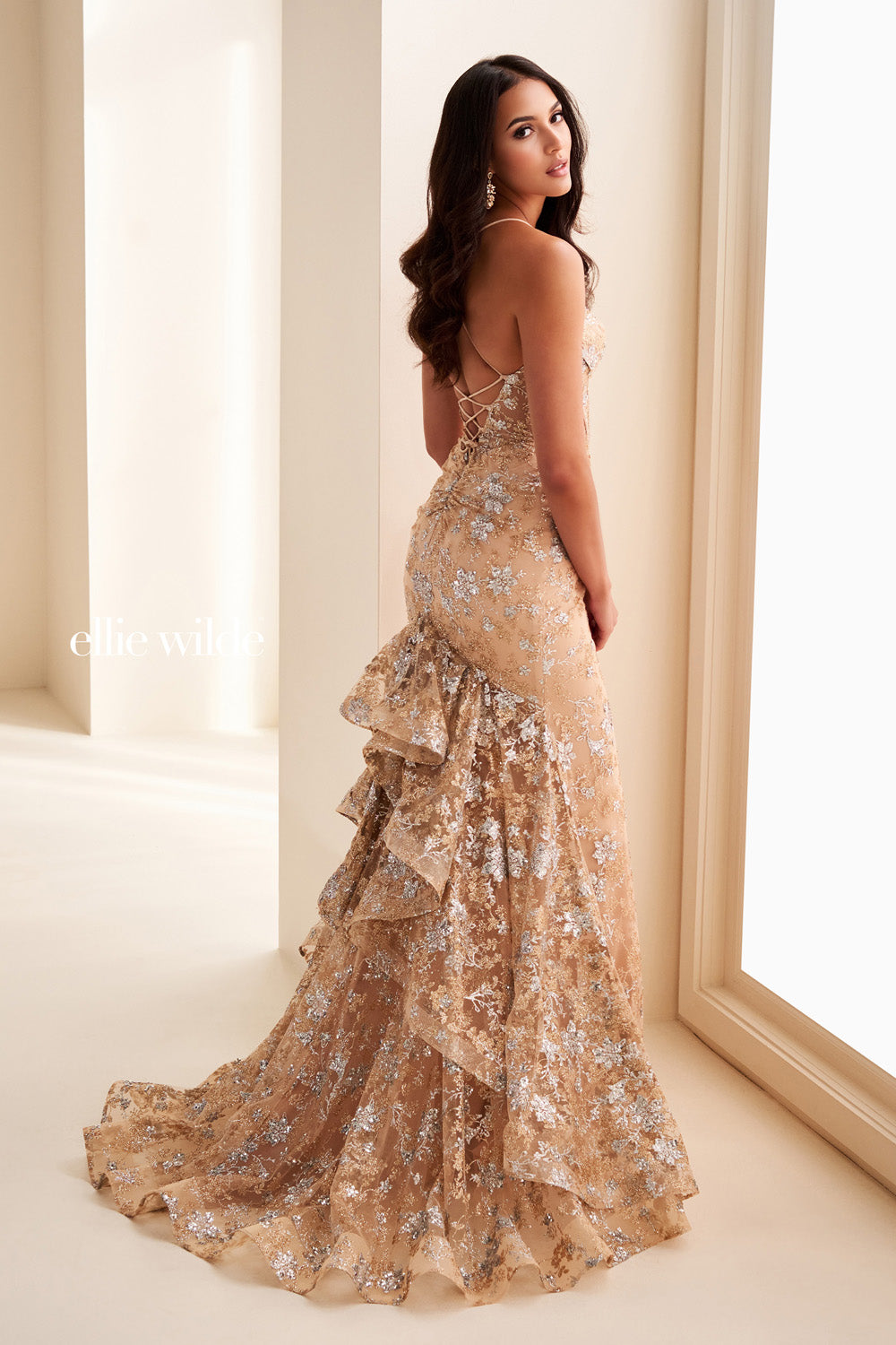 Ellie Wilde EW37051 nude gown with ruffled hem and floral embellishments prom dress images.