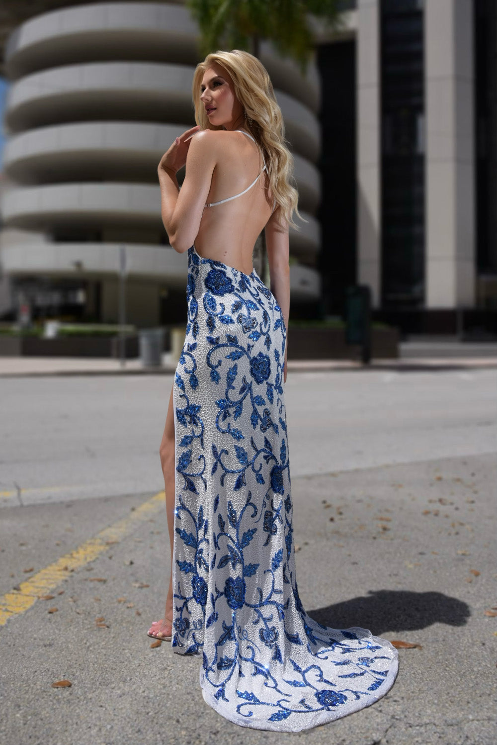 Jasz Couture 7923 White and blue mermaid prom dress with a high slit and open back view.
