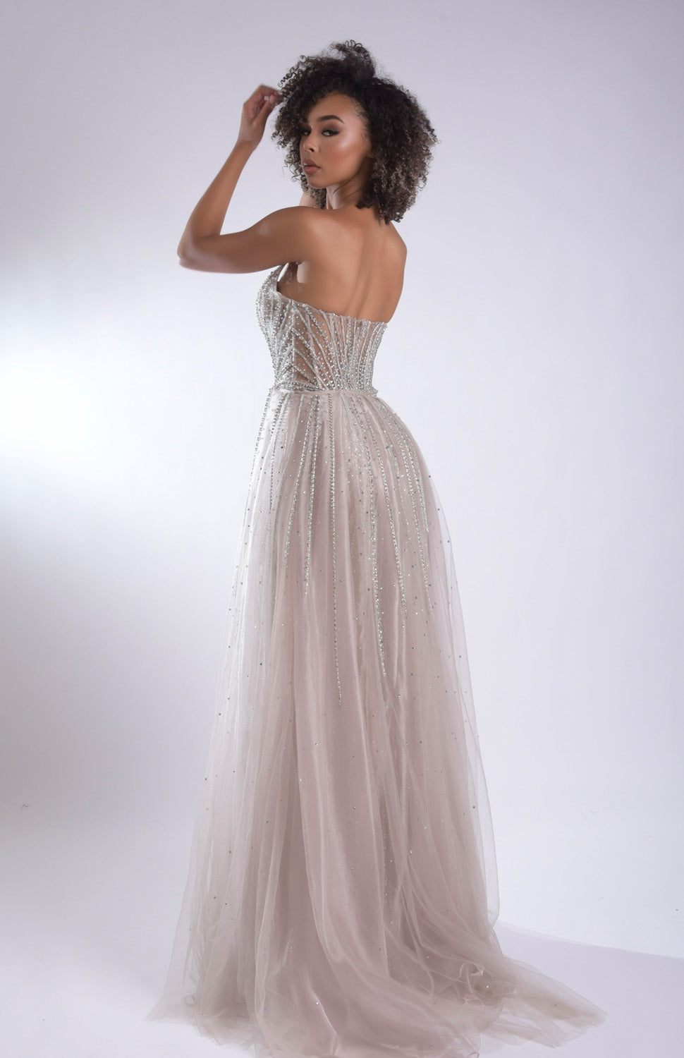 Jasz Couture 7932 Champagne formal gown with a fitted bodice and sparkling beaded details, back view.