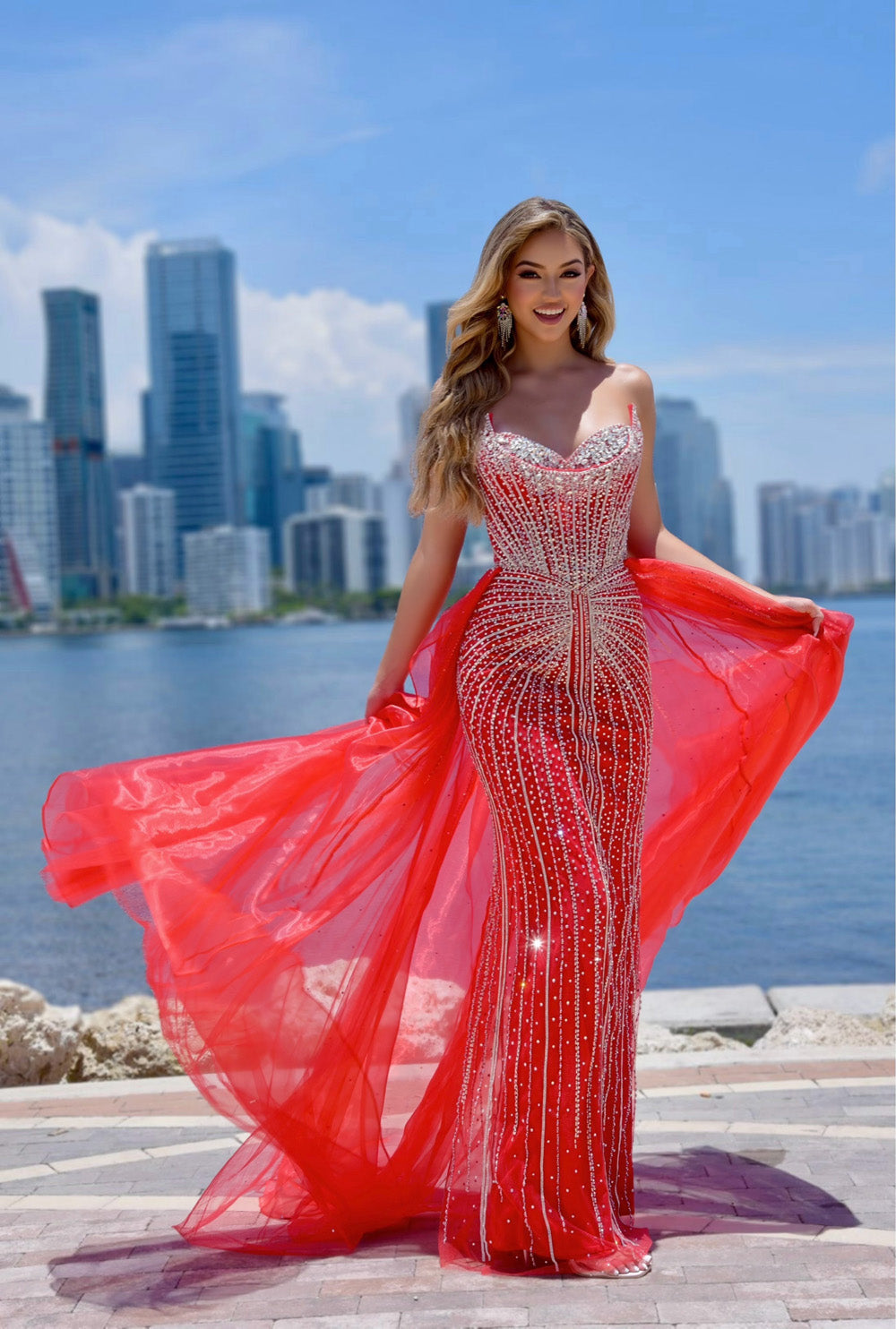 Jasz Couture 7932 Red mermaid prom dress with beading and a flowing train, front view.