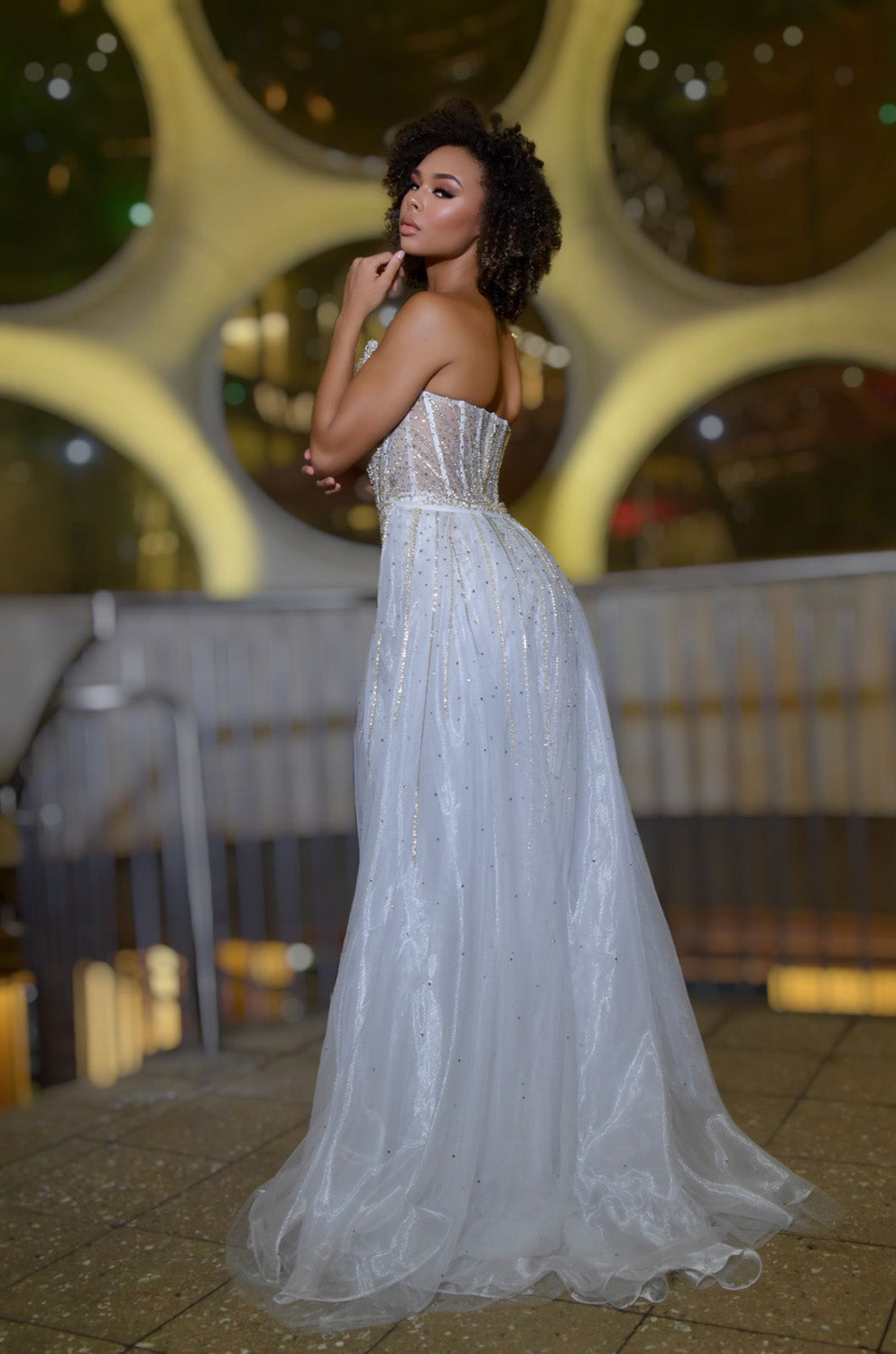 Jasz Couture 7932 White gold formal gown with a fitted silhouette and sparkling beaded details, back view.