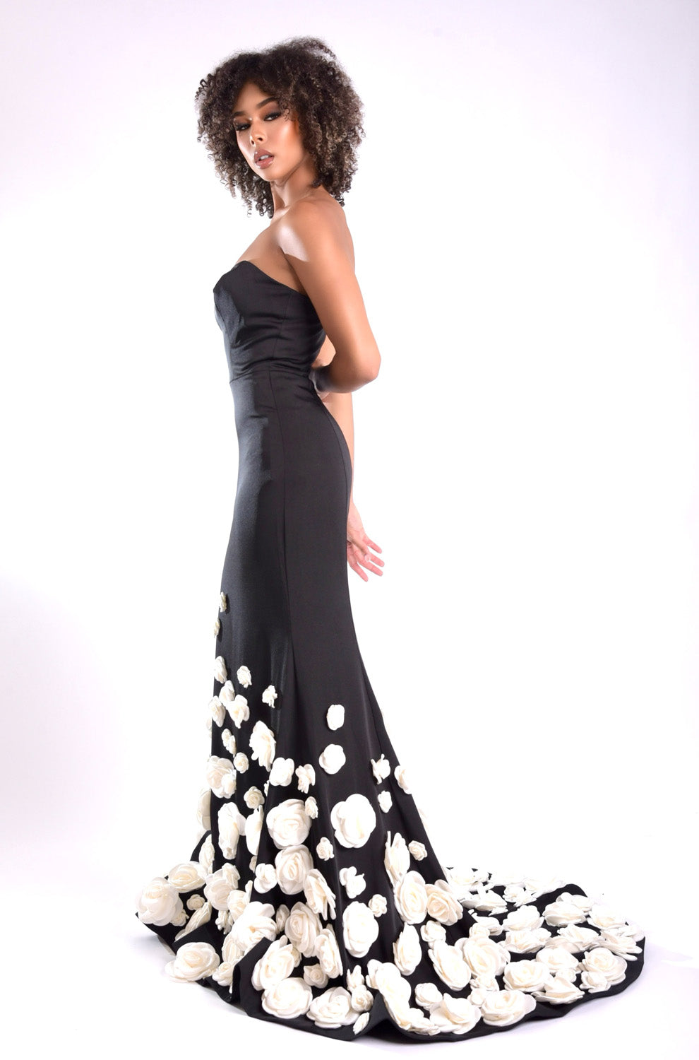 Jasz Couture 7945 Black mermaid prom dress with floral appliqués and a side slit.