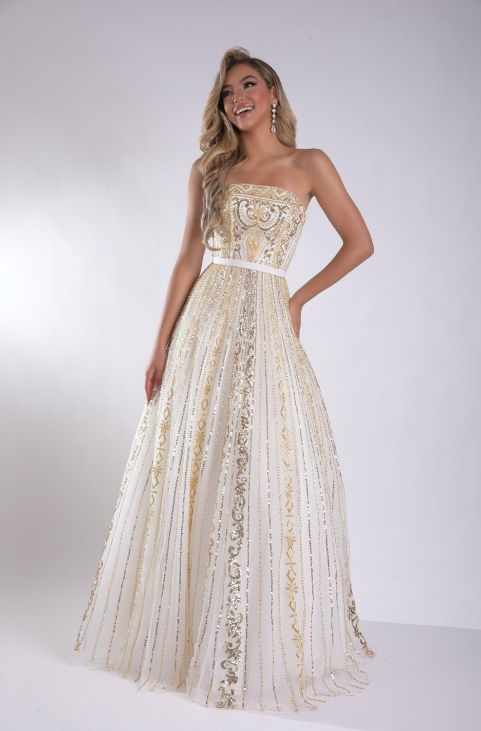 Jasz Couture 7952 Strapless white gold prom dress with intricate beading and flowing A-line silhouette.