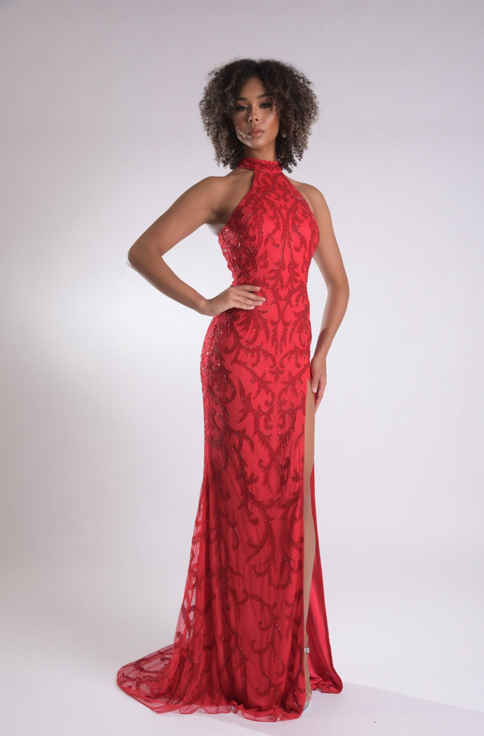 Jasz Couture 7956 Red mermaid prom dress with lace detailing and a thigh-high slit, front view.