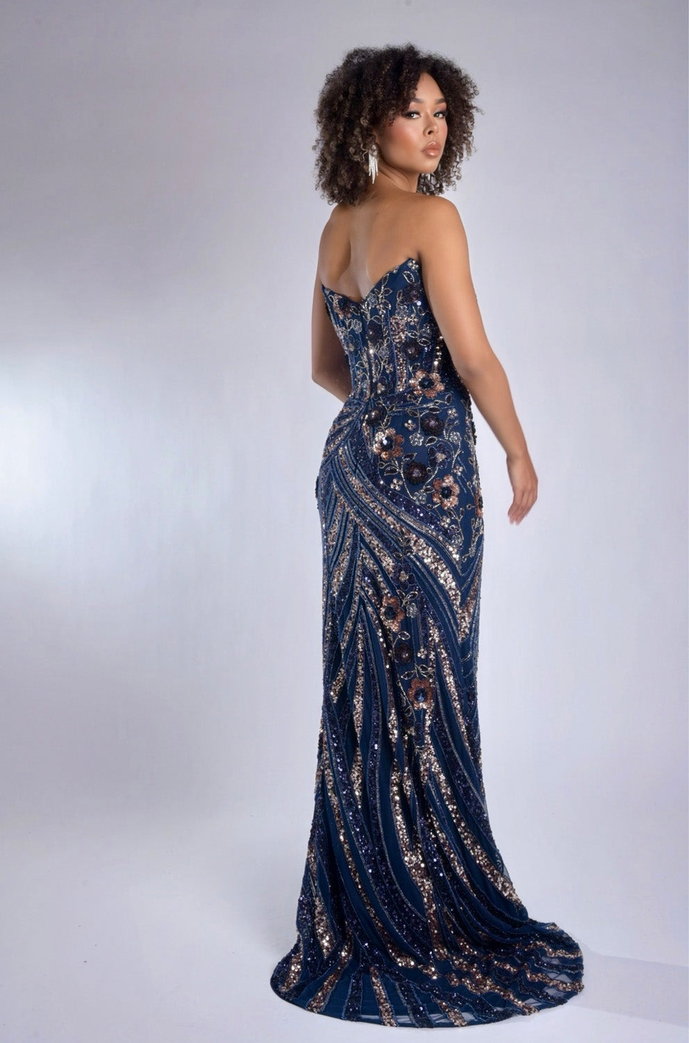 Jasz Couture 7979 Navy rose gold mermaid prom dress with intricate sequins and lace-up back, back view.