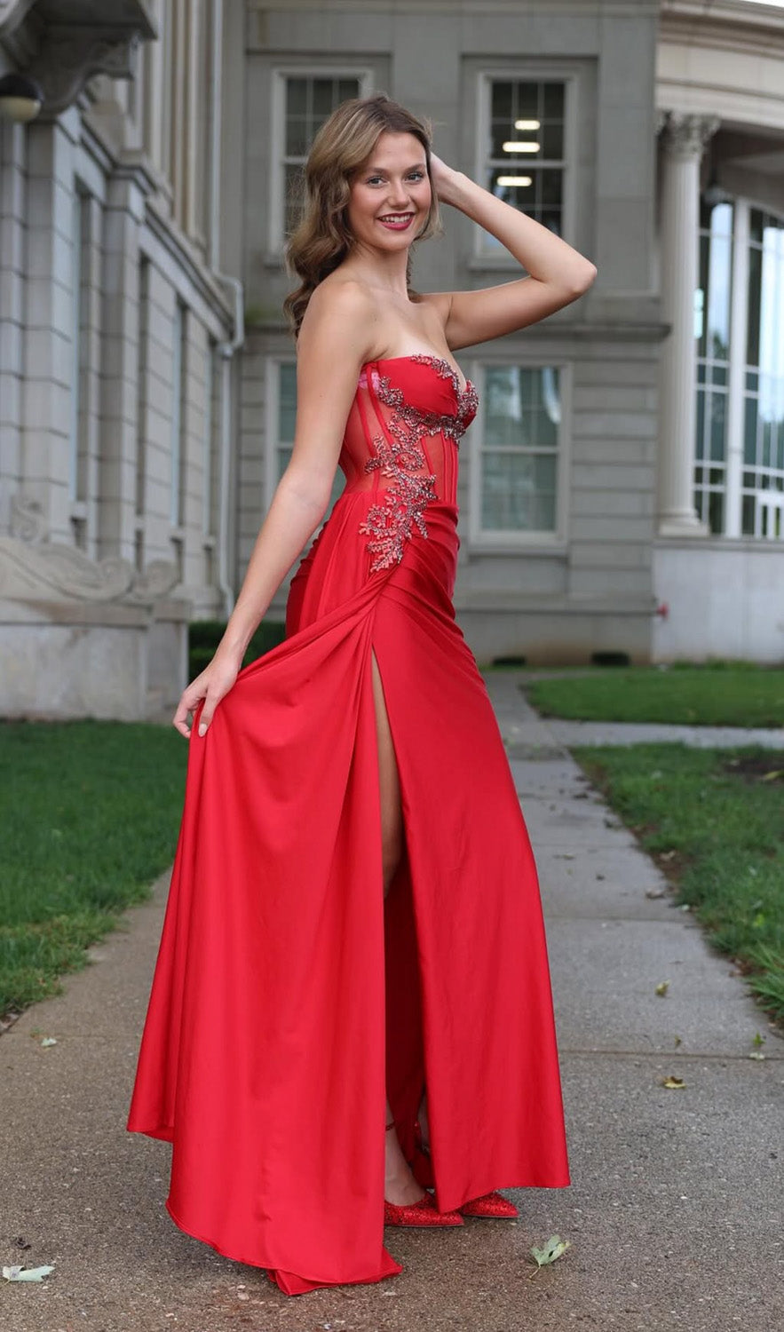 Jasz Couture 7982 Red prom dress with a fitted silhouette and a high slit, side view.
