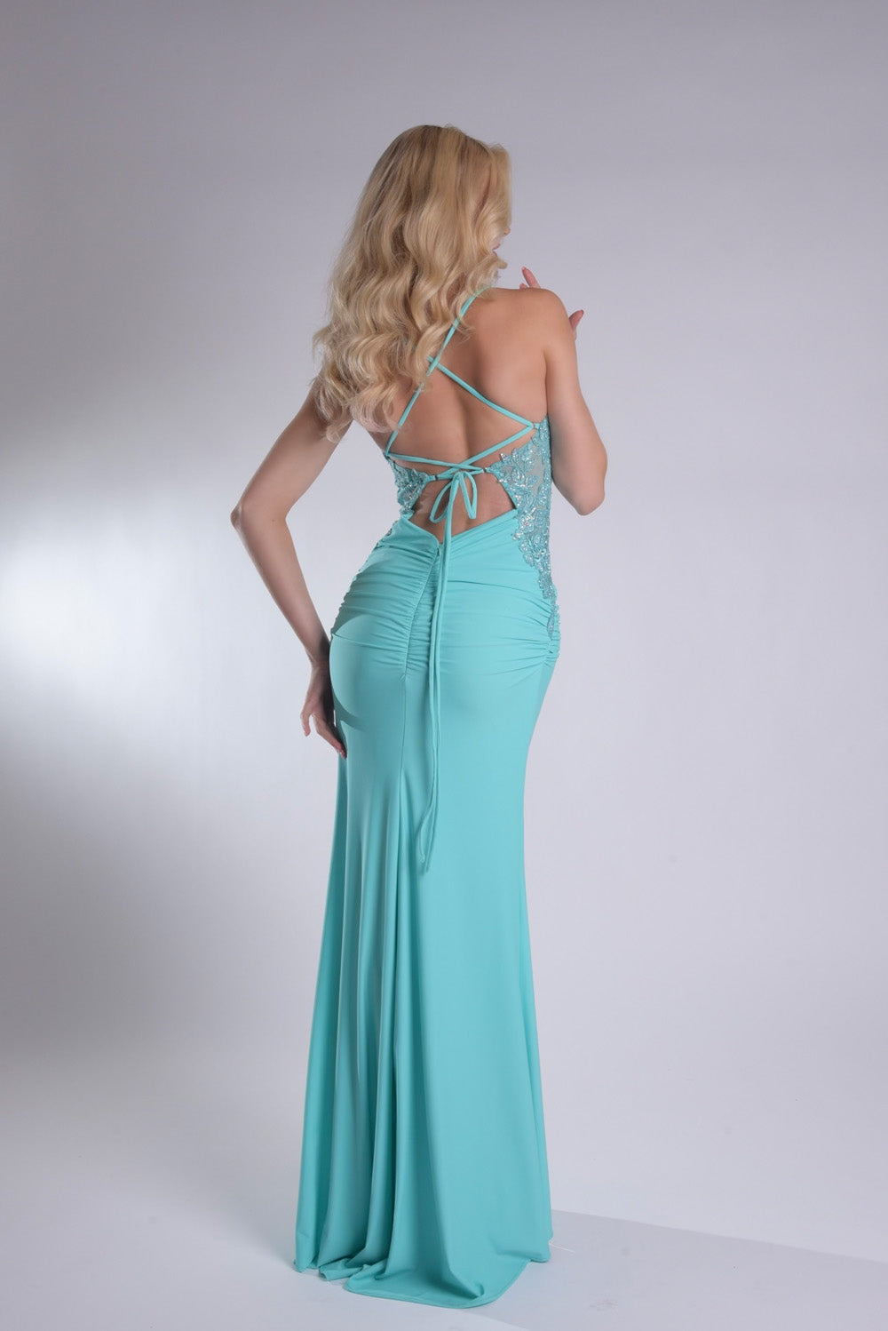 Jasz Couture 7985 Aqua mermaid prom dress with a lace-up back and elegant ruching, back view.