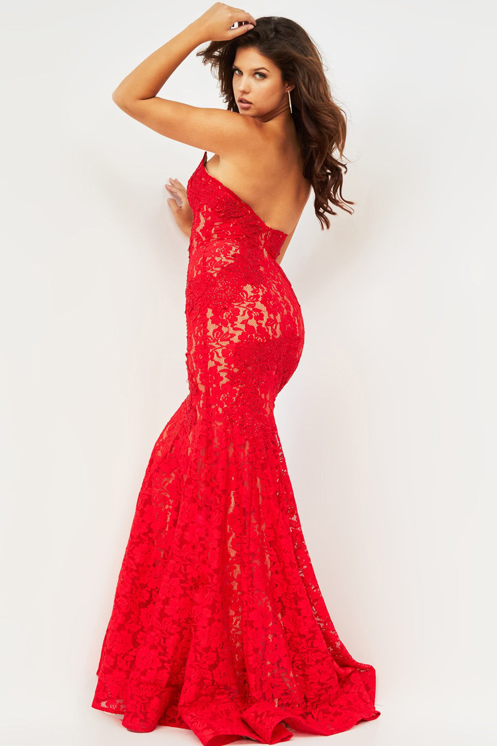 Jovani 37334 Red mermaid prom dress with lace overlay and open back, side view.