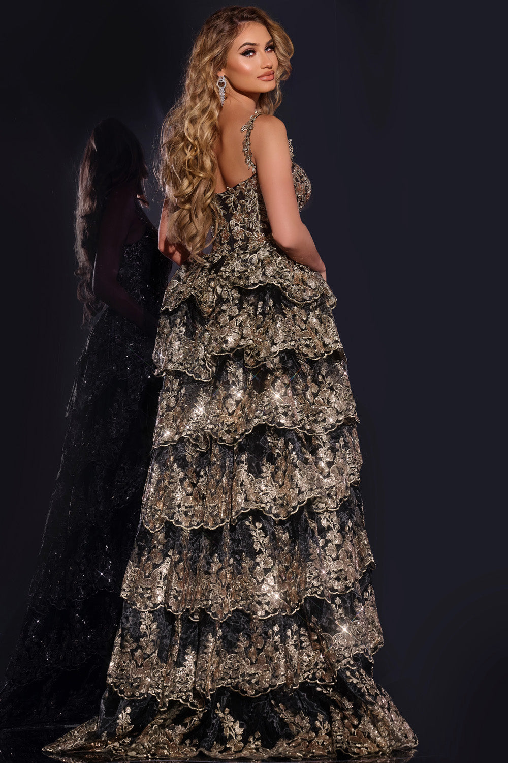 Jovani 37630 Black and gold tiered formal gown with intricate beading, back view.