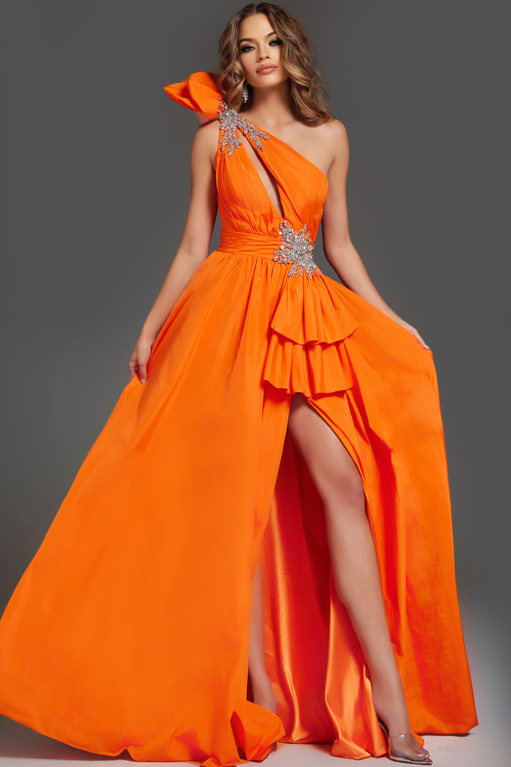 Jovani 40929 Orange prom dress with a fitted silhouette and a high slit, featuring sparkling embellishments.