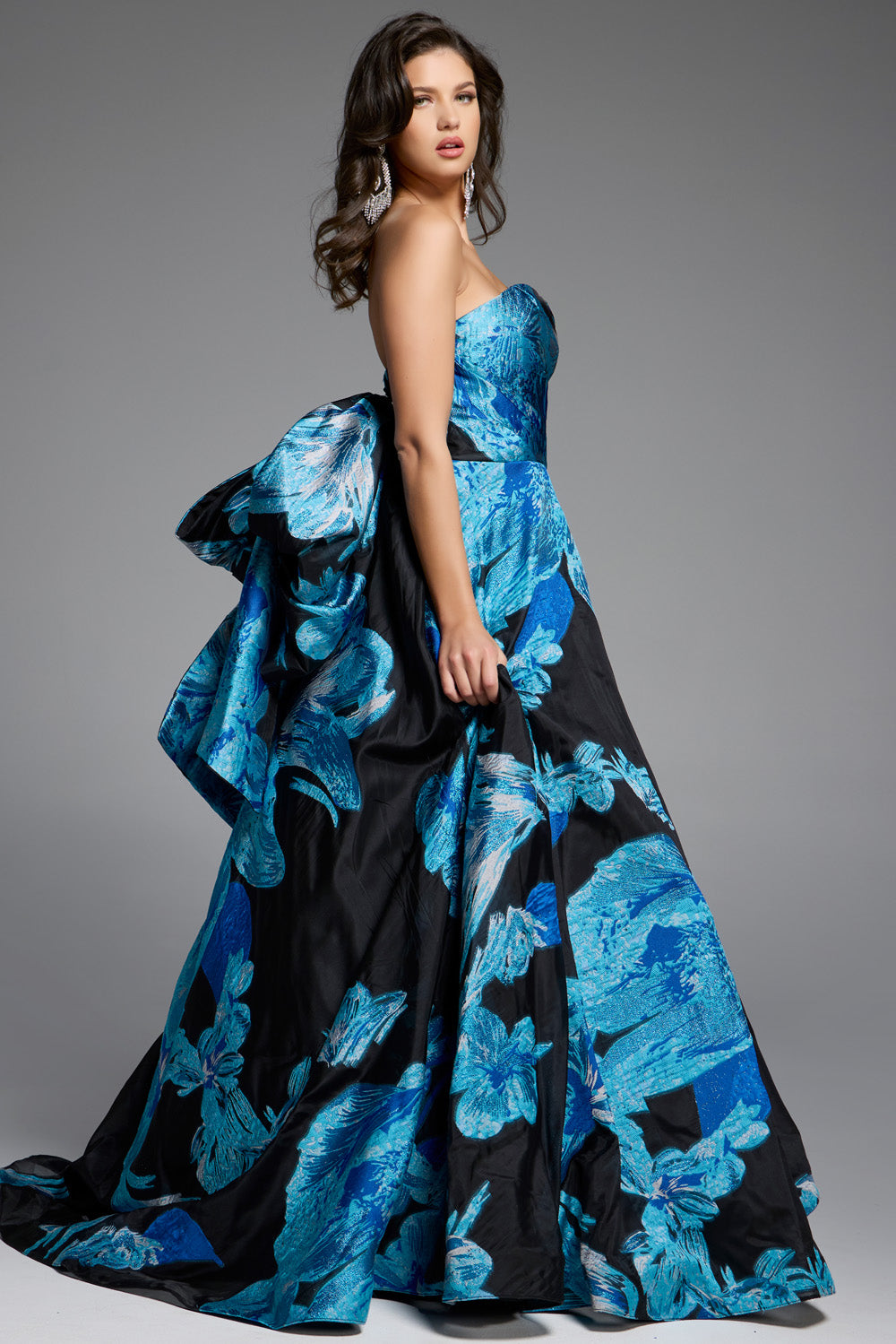 Jovani 42436 Blue and black floral ballgown with a dramatic bow and strapless neckline prom dress.