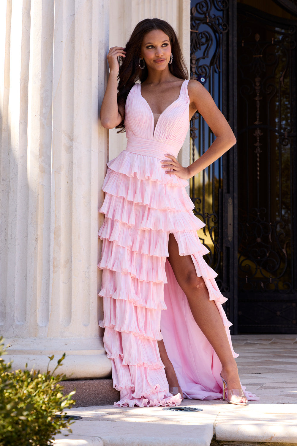 Jovani 43160 Pink prom dress with ruffled layers and a high slit, side view.
