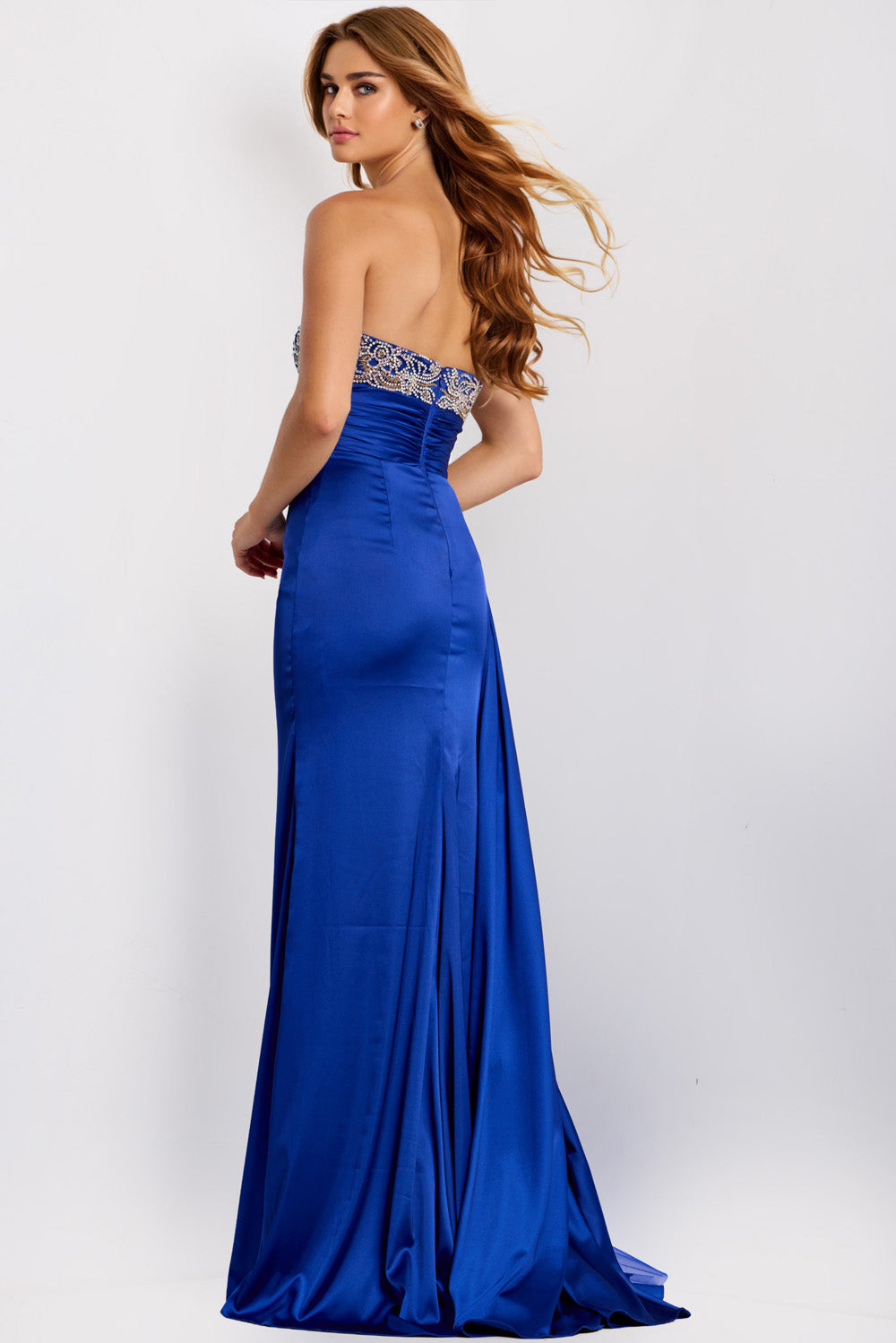 Jovani 43674 Royal blue fitted prom dress with beaded bodice and side slit, back view.
