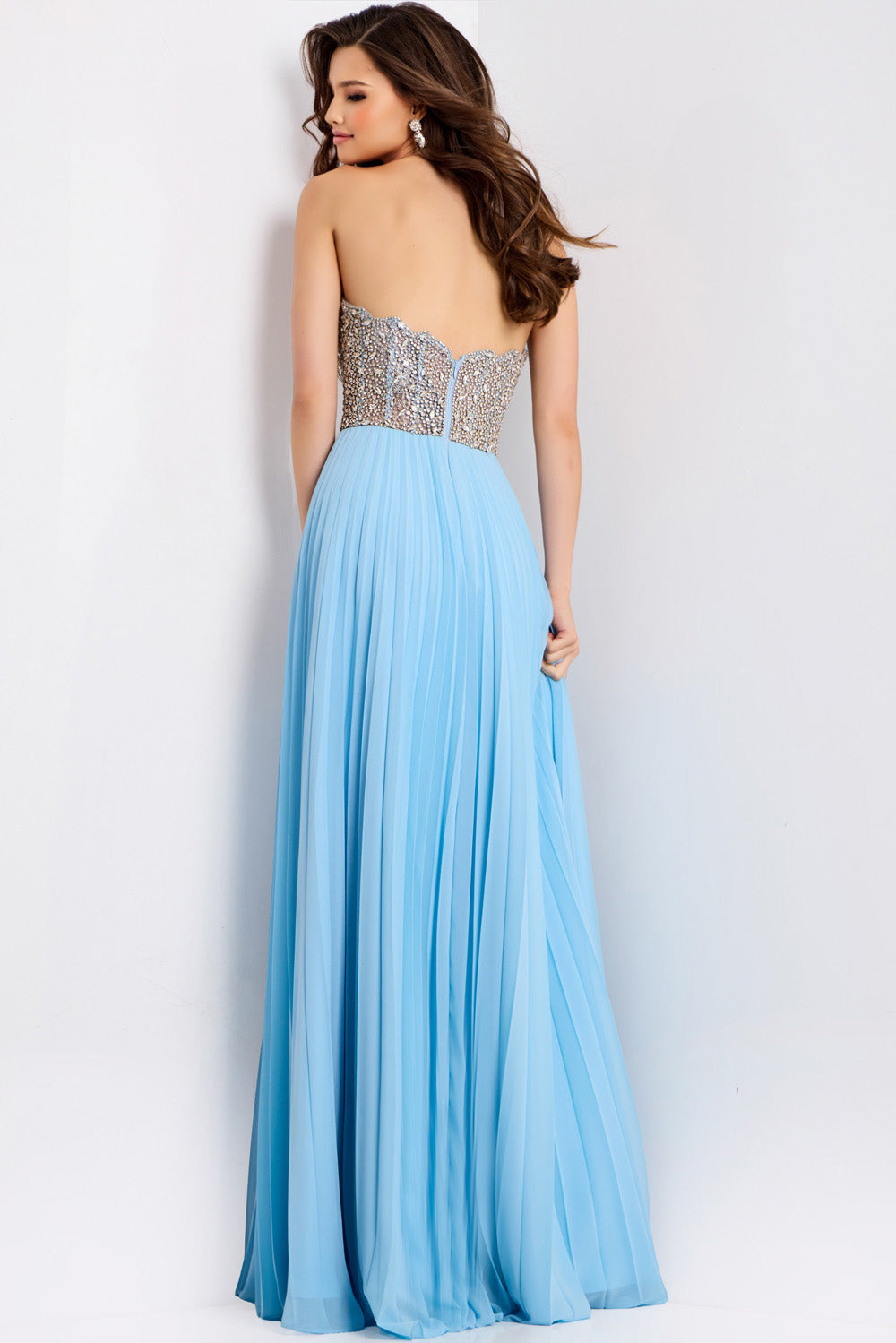 Jovani 44358 Light blue formal gown with a fitted beaded bodice and pleated skirt, back view.