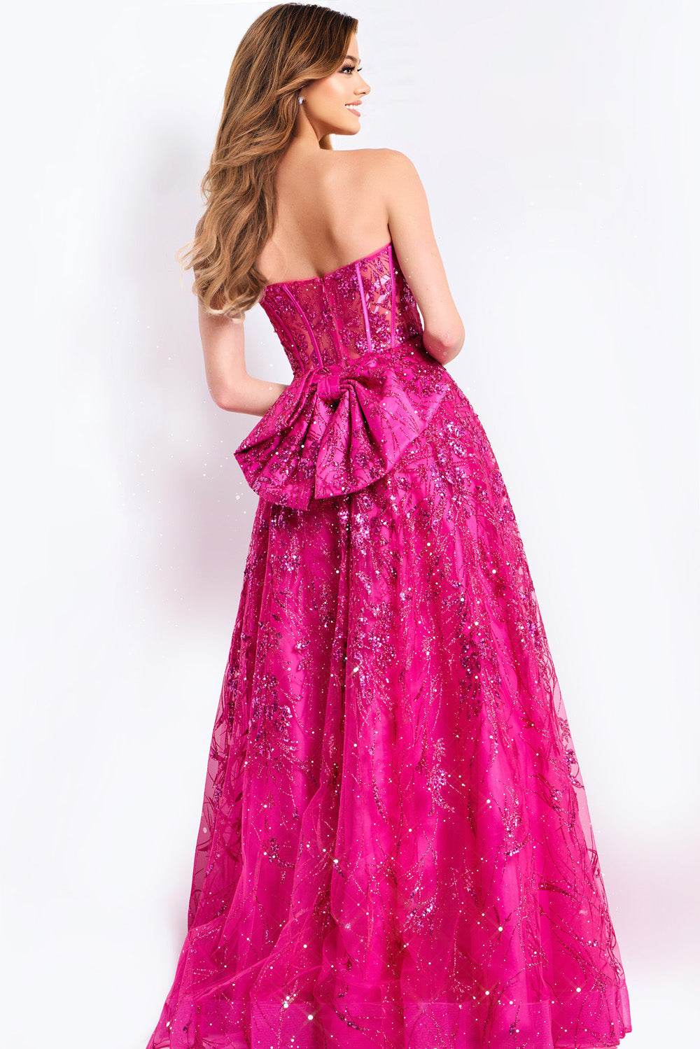 Jovani 45913 Pink formal gown with a fitted bodice, sequins, and a dramatic bow at the back.