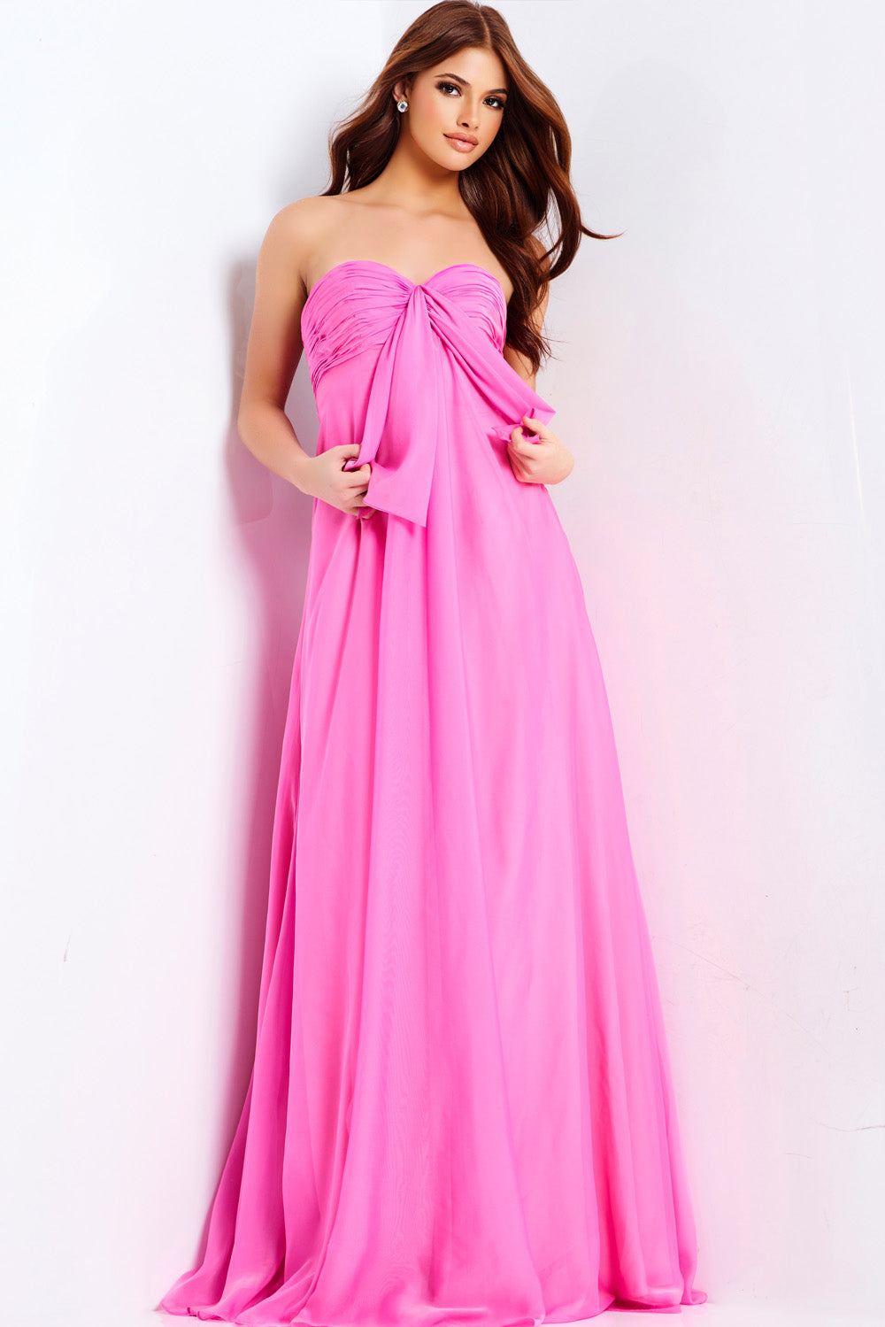 Jovani 47041 Hot pink strapless prom dress with a flowing silhouette and bow detail.
