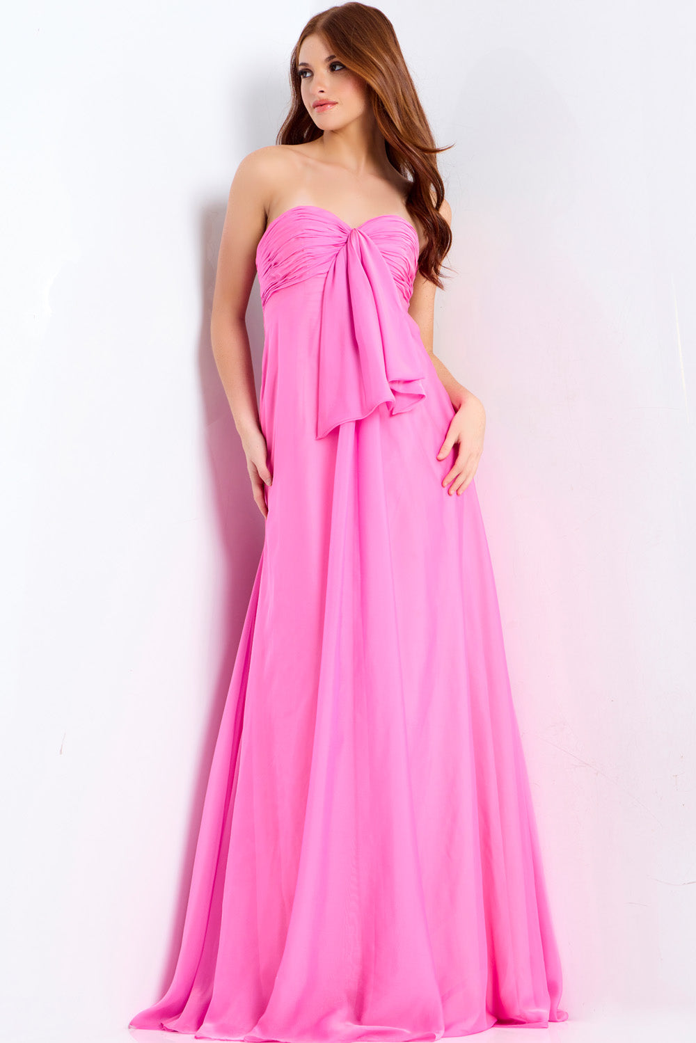 Jovani 47041 Hot pink strapless prom dress with a flowing silhouette and elegant bow detail.