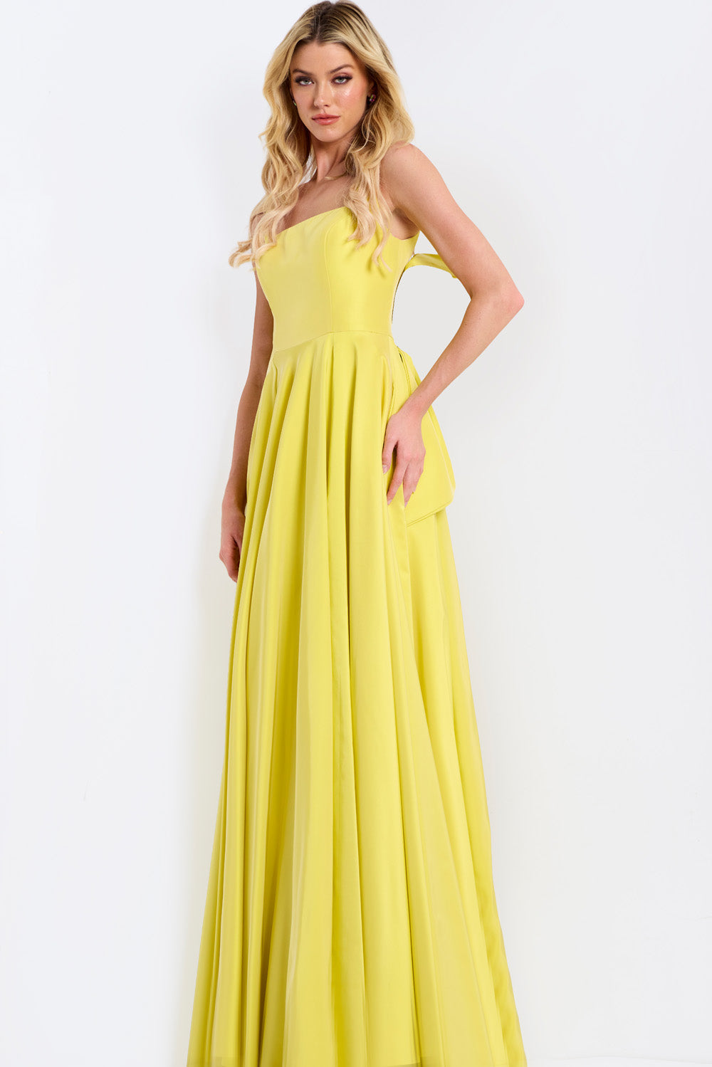 Jovani 47496 Yellow A-line prom dress with pleated skirt and strapless neckline, side view.
