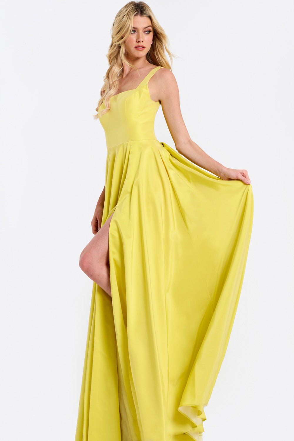 Jovani 47496 Yellow A-line prom dress with a high slit and flowing skirt, front view.