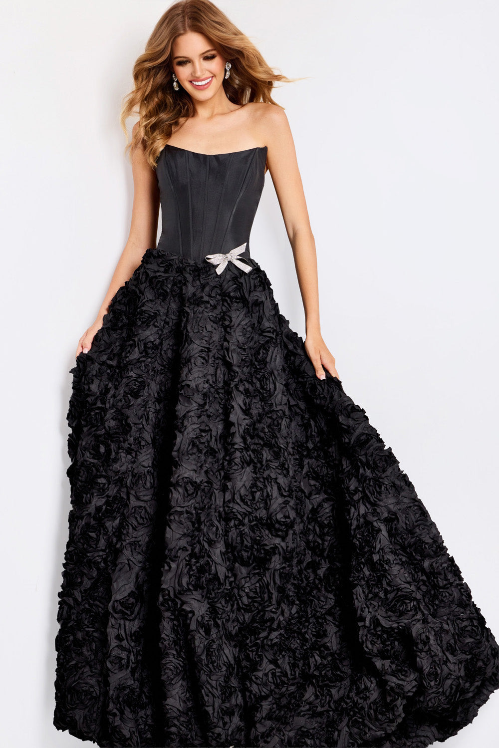 Jovani 47695 Black ballgown prom dress with floral texture and a sparkling bow detail.