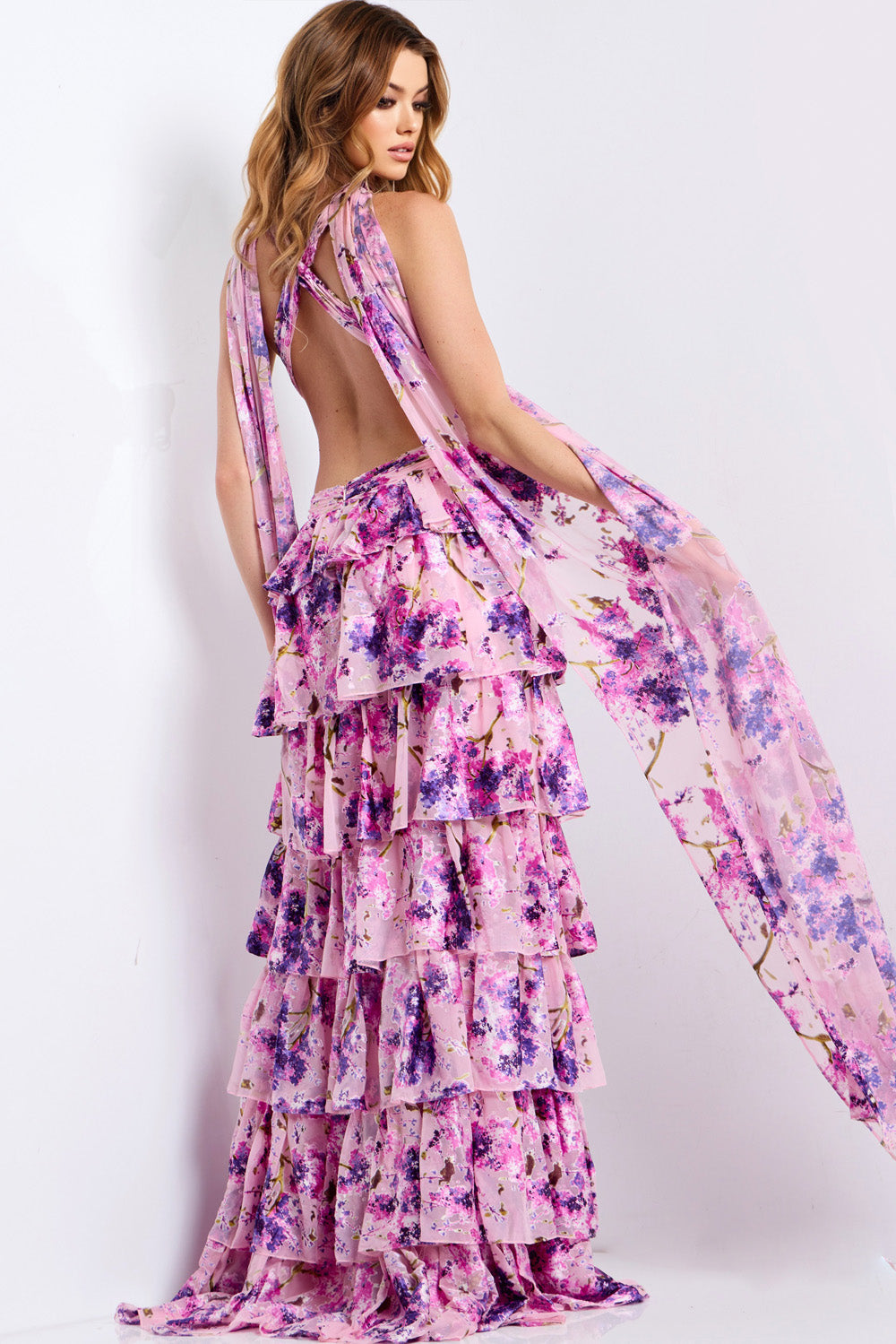 Jovani 48234 Pink tiered prom dress with a lace-up back and flowing cape detail, back view.