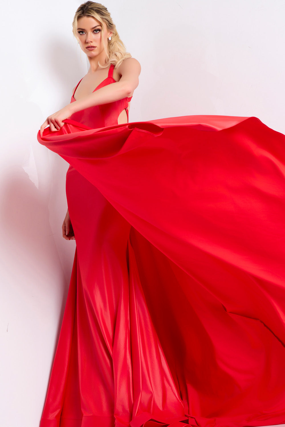 Jovani 48291 Red mermaid prom dress with a dramatic slit and flowing train, front view.
