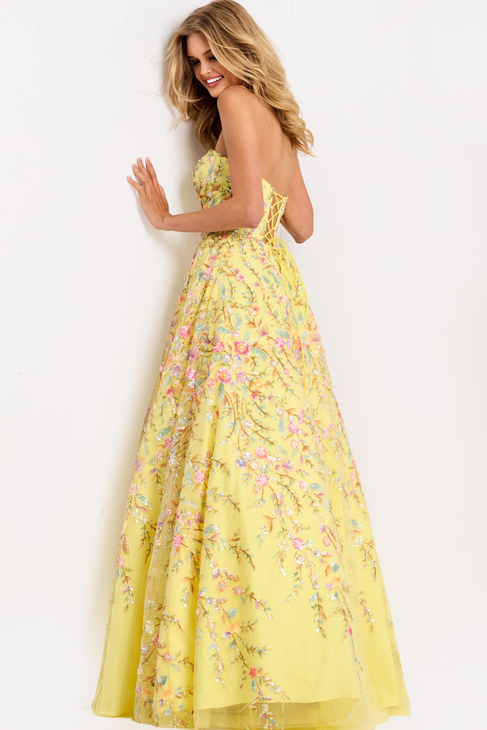 Jovani 49070 Yellow A-line prom dress with floral embroidery and lace-up back, back view.