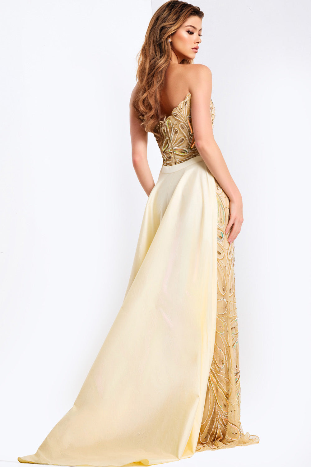 Jovani 49255 Off white nude formal gown with beaded bodice and flowing skirt, back view.