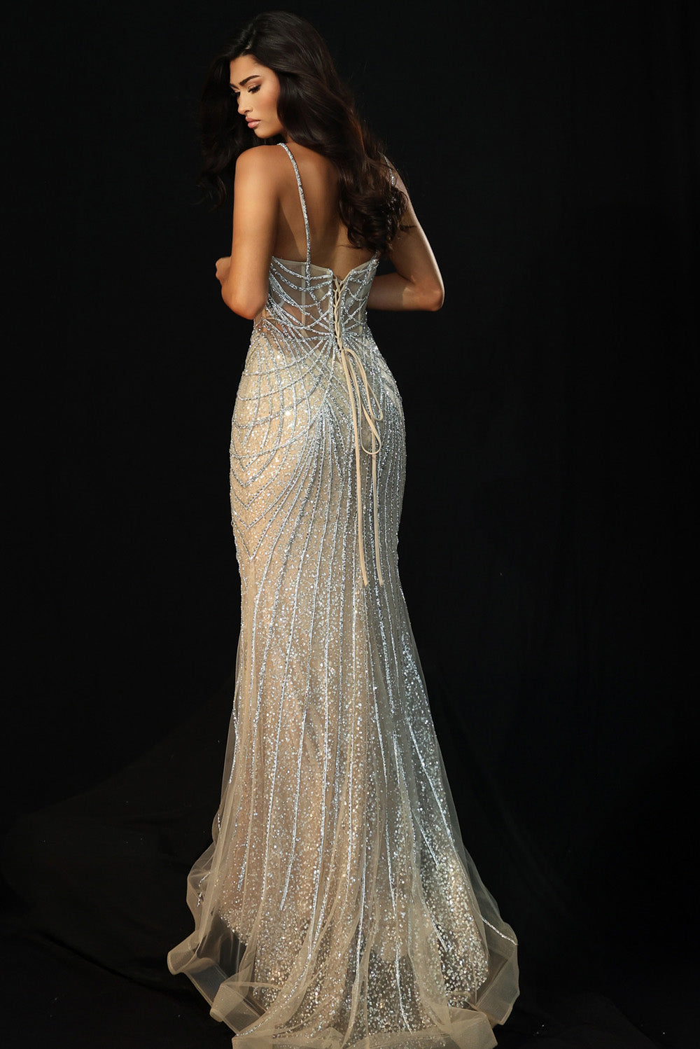 Jovani 49718 Silver nude formal gown with a fitted silhouette and lace-up back, back view.