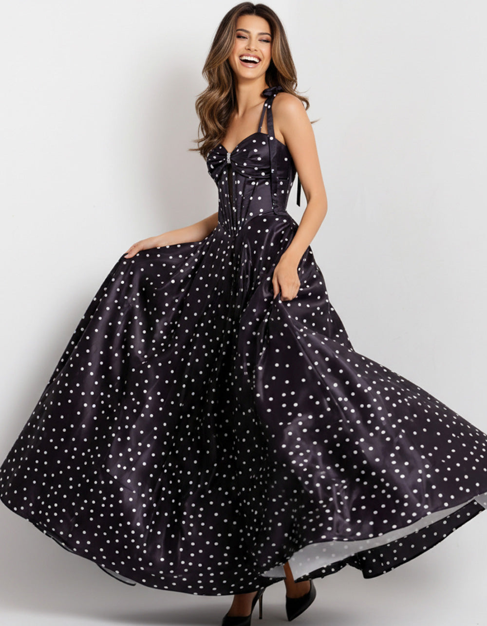 Jovani 49774 Black polka dot prom dress with a fitted bodice and flowing A-line skirt.