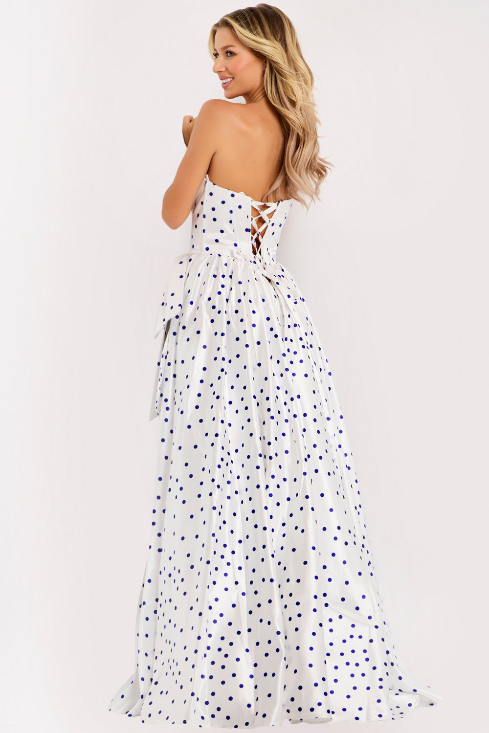 Jovani 49899 White polka dot prom dress with a fitted bodice and lace-up back, back view.