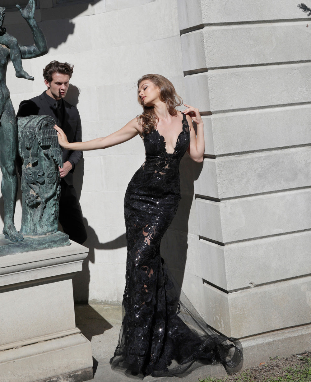 Jovani 60283 Black mermaid prom dress with sequins and a plunging neckline, side view.