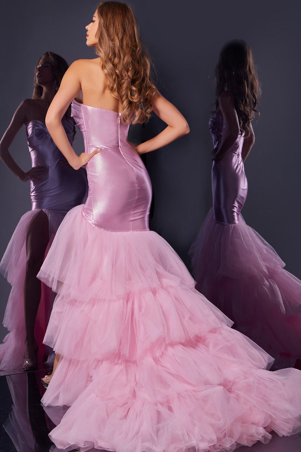 Jovani D5315 Pink mermaid prom dress with layered tulle skirt and lace-up back, back view.