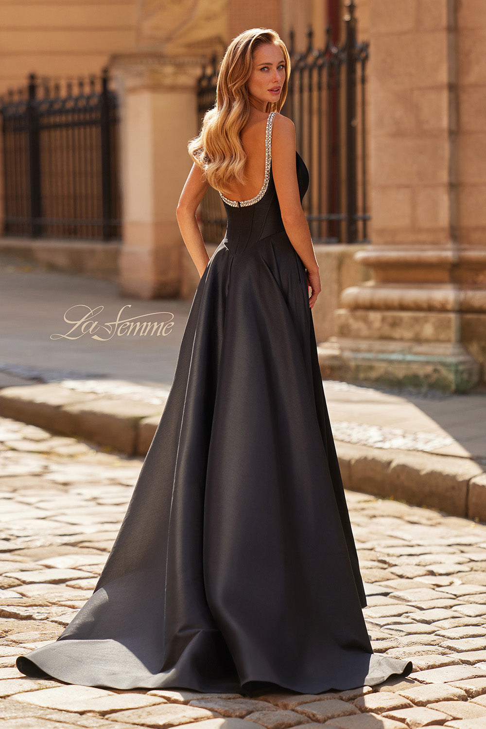 La Femme 33106 Black A-line prom dress with rhinestone detailing and a dramatic back view.