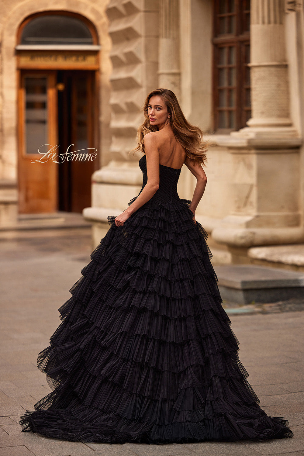 La Femme 33202 Black tulle ballgown with layered ruffles and a strapless design, back view prom dress.