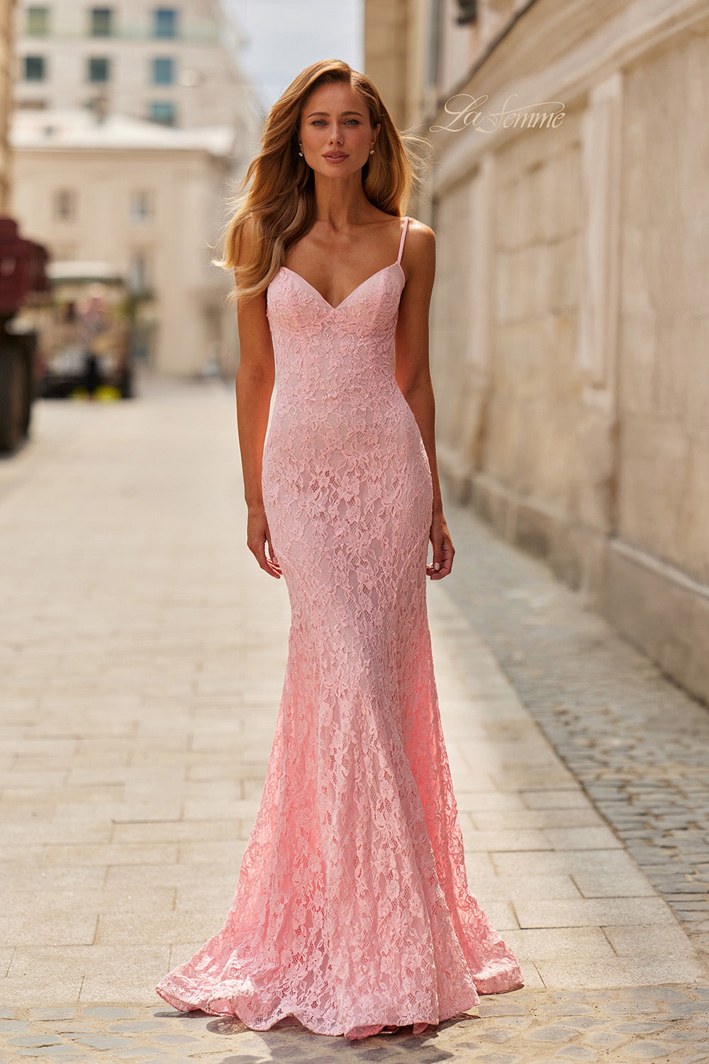 La Femme 33452 Baby pink lace mermaid prom dress with a plunging neckline and spaghetti straps.