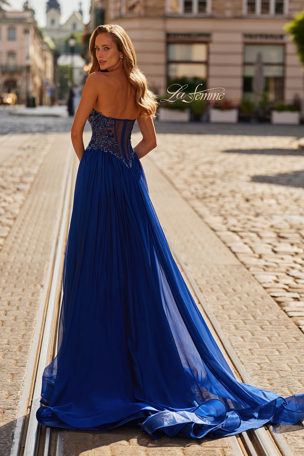 La Femme 33552 Marine blue formal gown with beaded bodice and flowing A-line silhouette, back view.