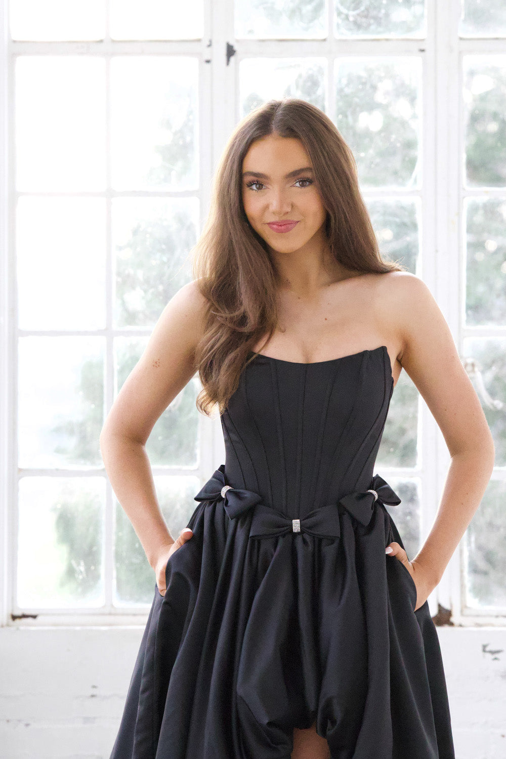 Miah Vega 24601 Black strapless prom dress with a fitted bodice and playful bow details.