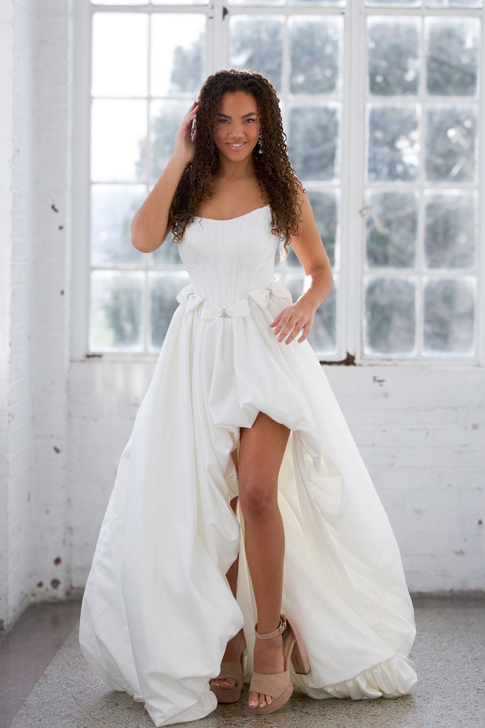 Miah Vega 24601 White A-line prom dress with a high slit and strapless neckline.