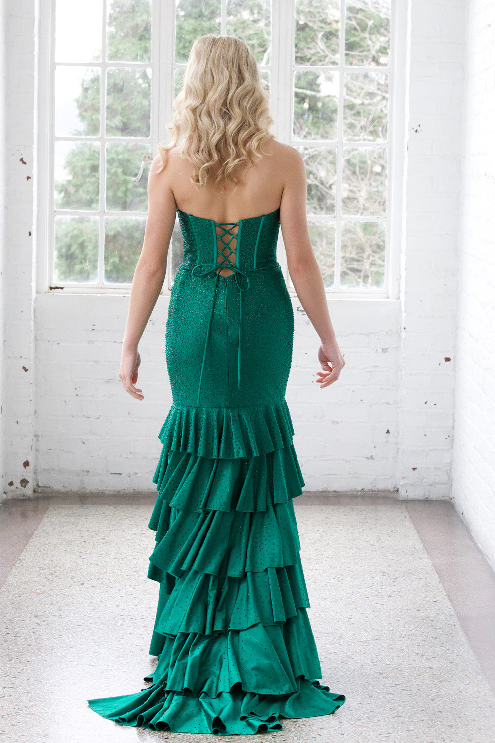 Miah Vega 24606 Emerald mermaid prom dress with a lace-up back and tiered ruffle skirt.