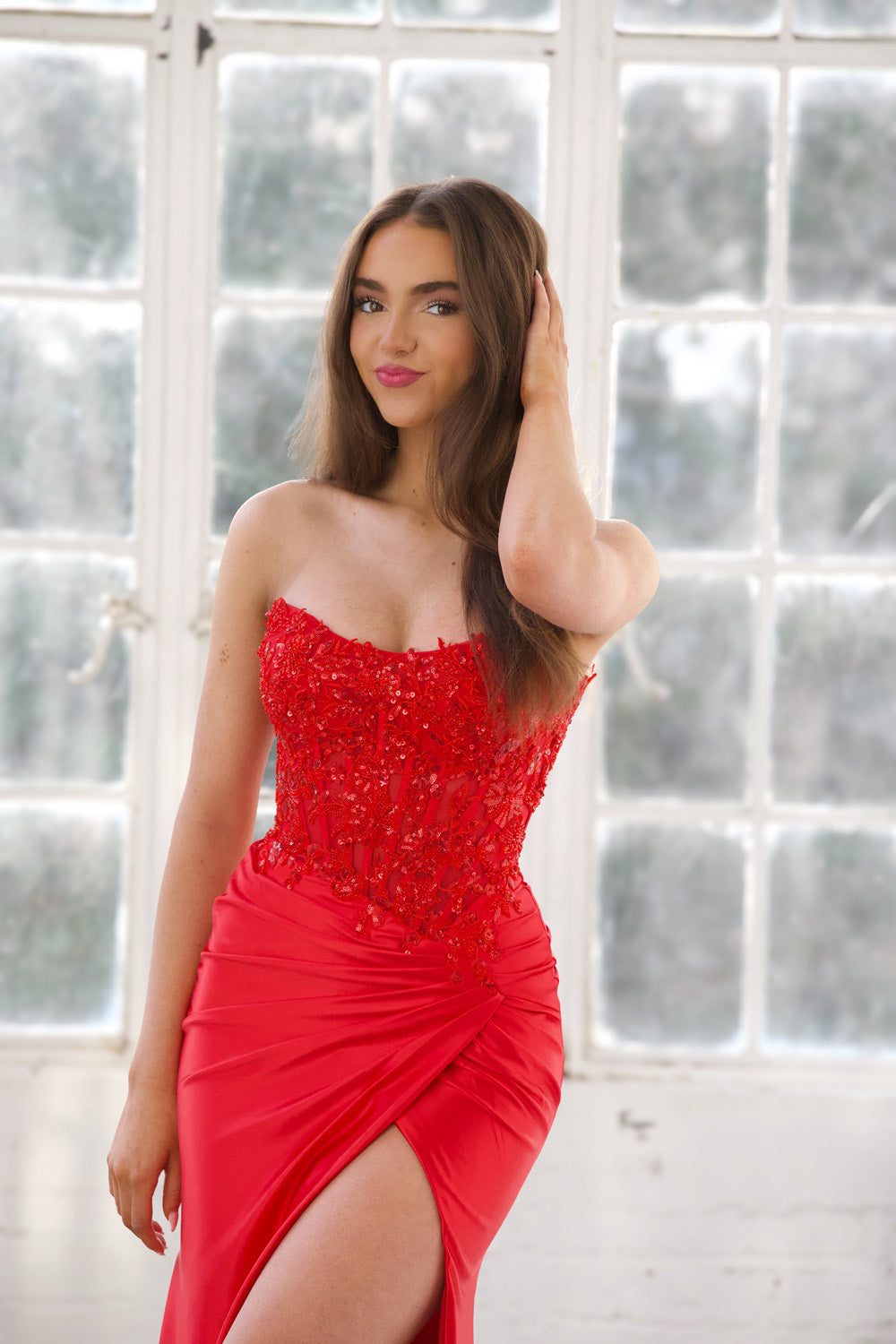 Miah Vega 24607 Red mermaid prom dress with beaded bodice and thigh-high slit, front view.