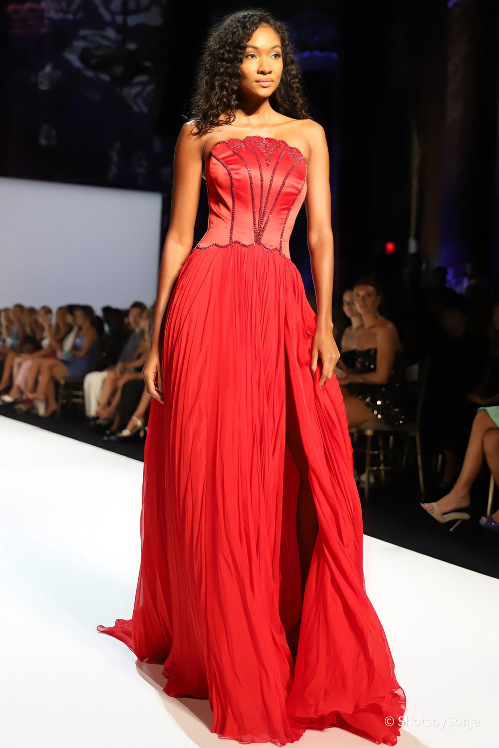 Sherri Hill 46703 red couture gown with structured beaded bodice and flowing pleated chiffon ballgown skirt