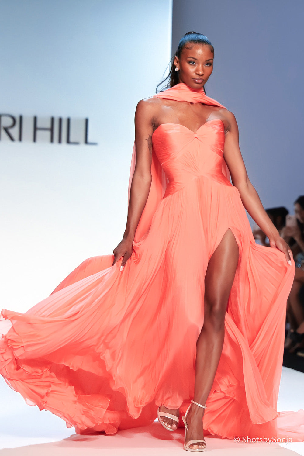 Sherri Hill 46715 coral strapless pleated chiffon gown with draped neck accent and sweeping floor length skirt