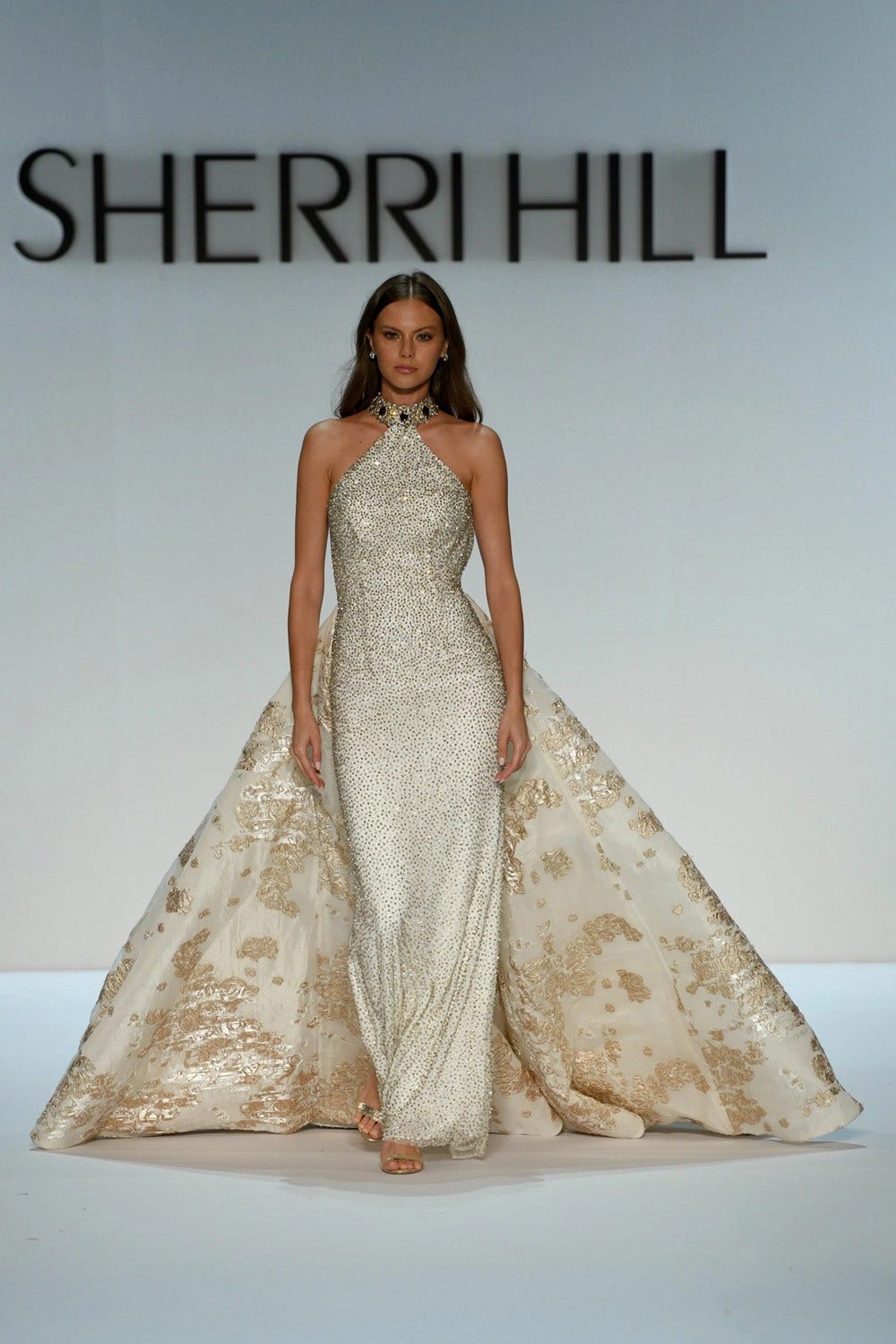 Sherri Hill 46751 ivory gold fitted beaded halter gown with full floral brocade overskirt front view