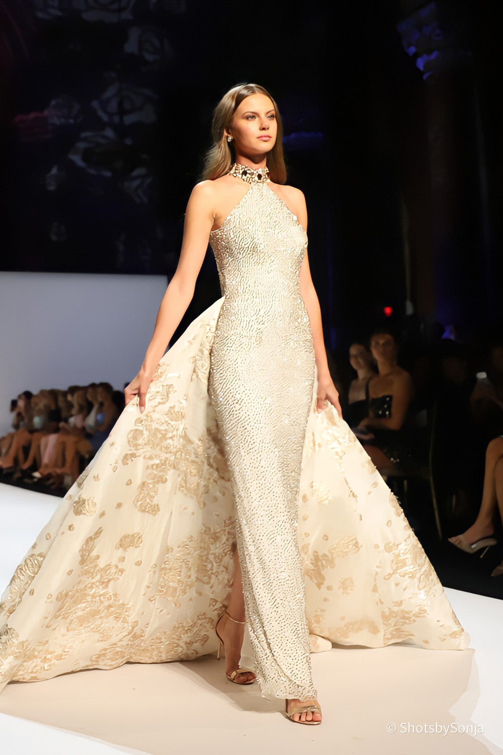 Sherri Hill 46751 ivory gold beaded high neck gown with open back and gold floral overskirt side angle