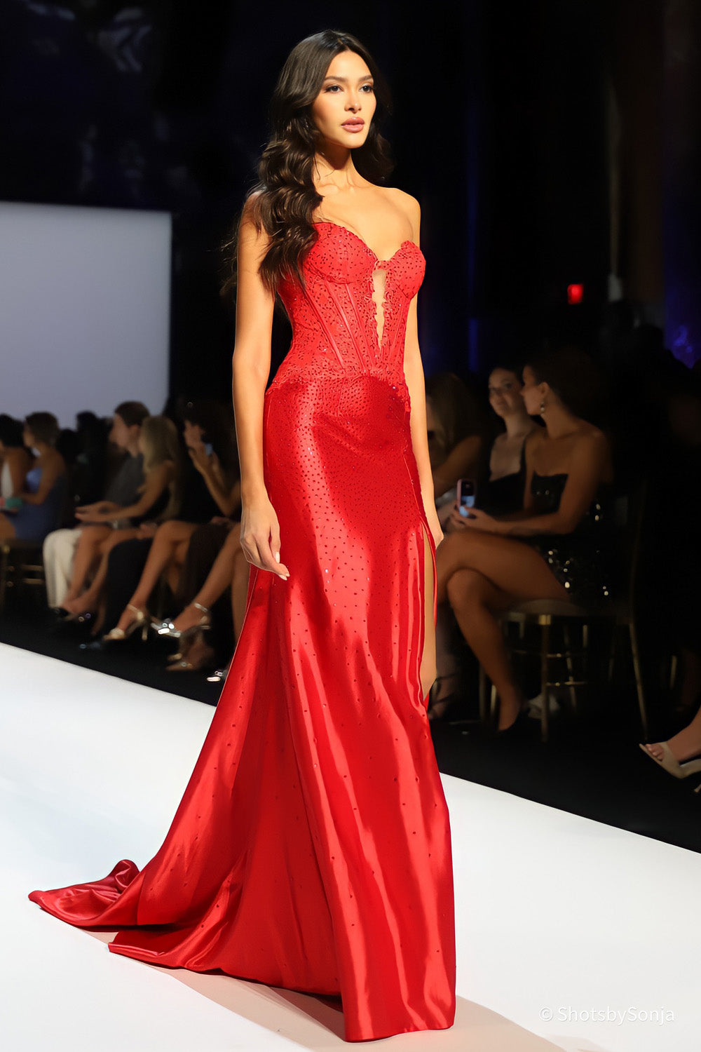 Sherri Hill 58469 red strapless corset gown with scattered beading on satin mermaid skirt side runway angle