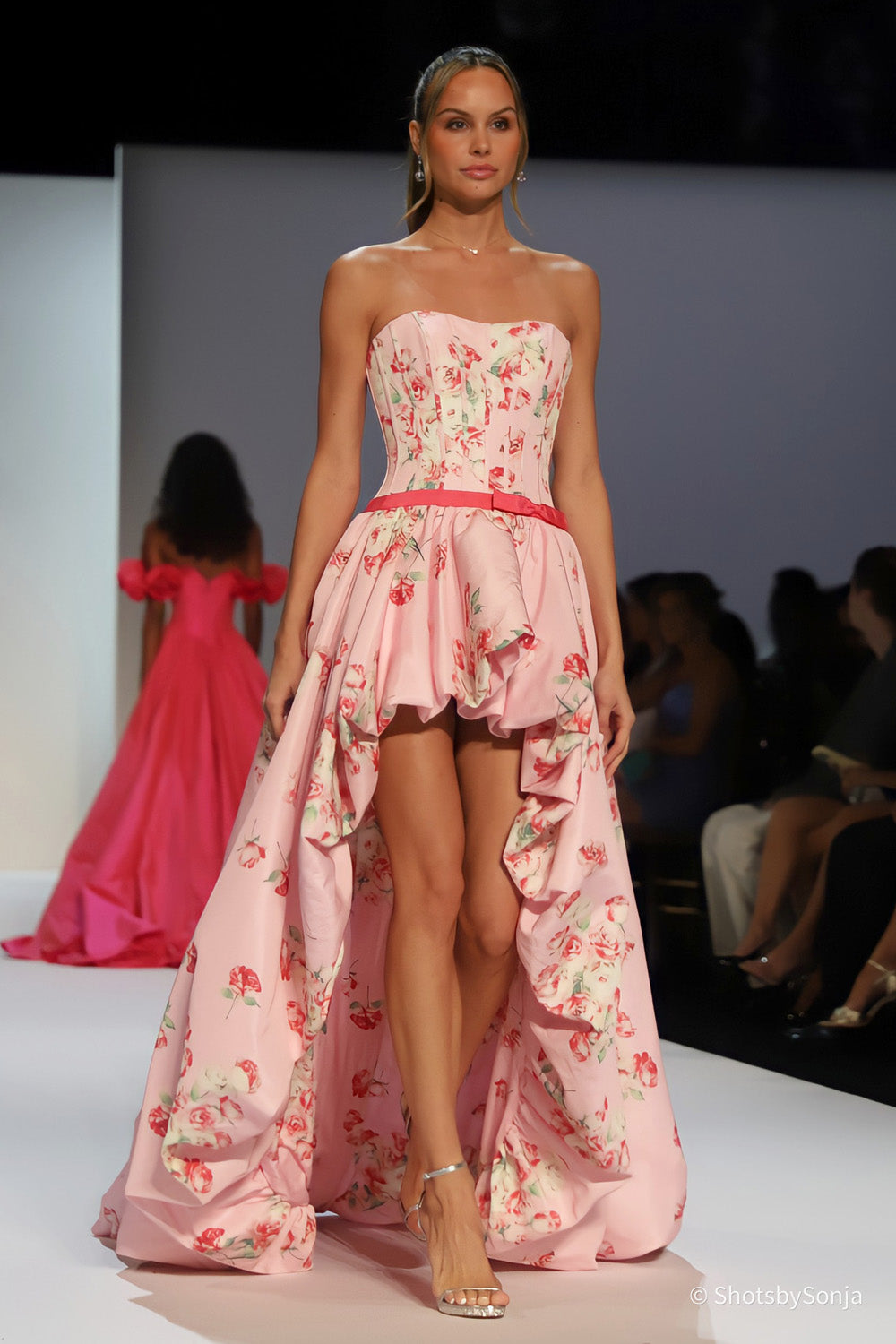 Sherri Hill 58652 pink print strapless corset bodice with high-low rose print skirt front view on runway